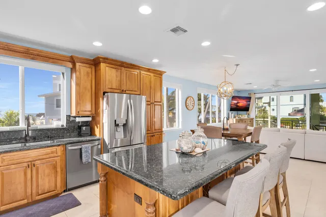 a view of a dining room with furniture a chandelier and wooden floor