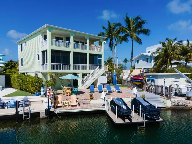 a front view of a house with swimming pool and sitting area