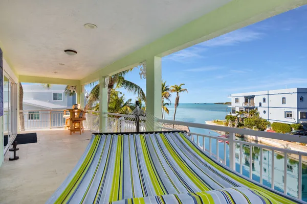 a living room with furniture gym equipment and a large window