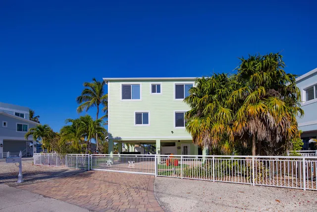 a front view of a house with outdoor seating