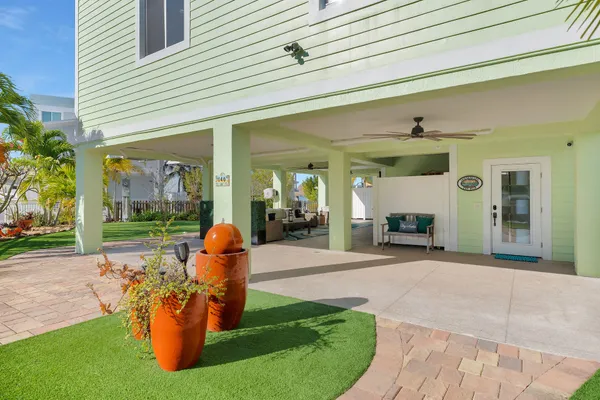a view of a house with a big yard and potted plants