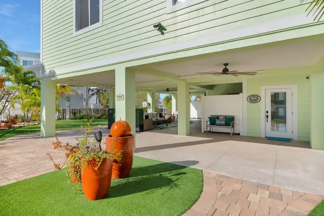a view of a house with a big yard and potted plants