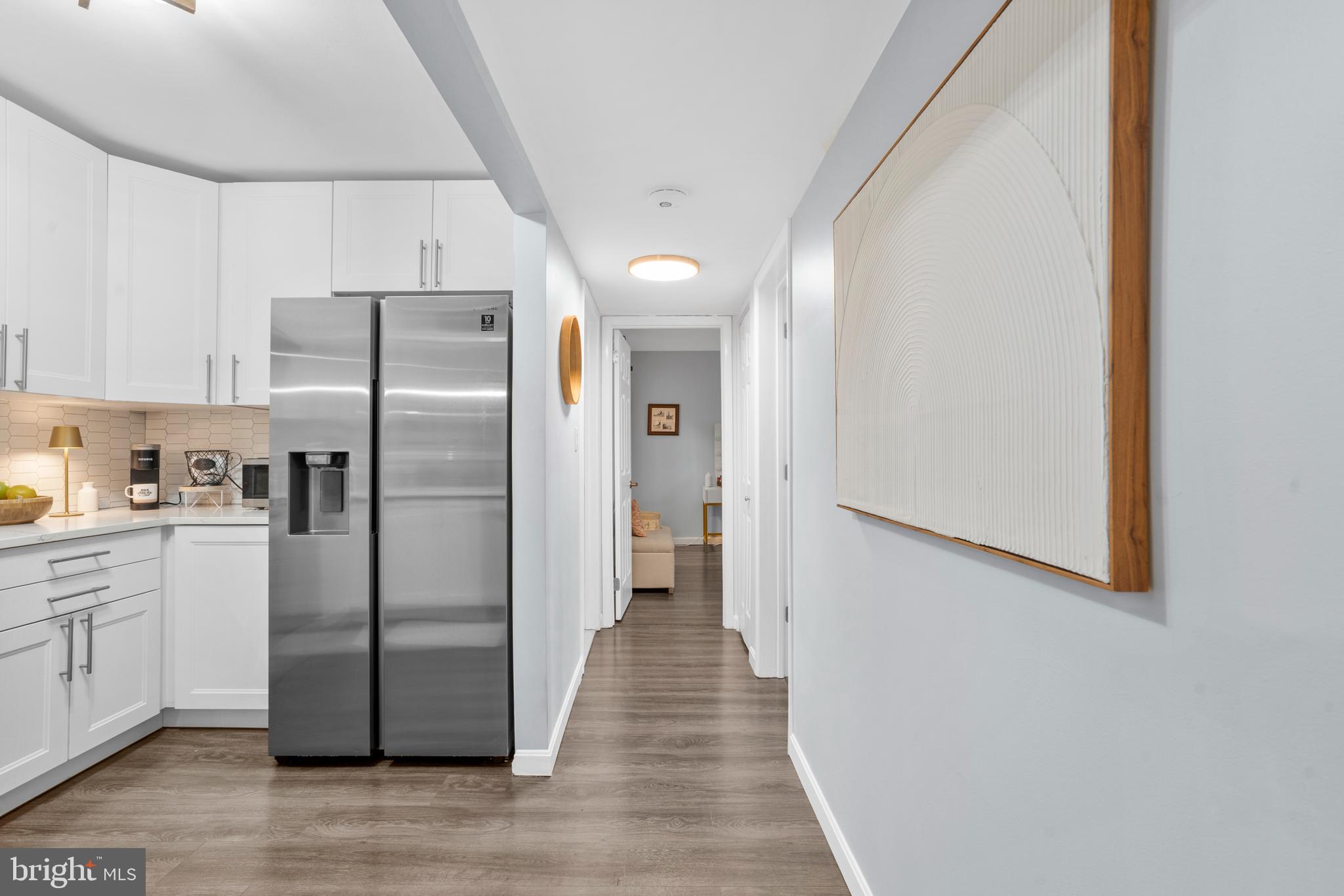 25 Church Road, Unit 56 Maple Shade, NJ 08052 - Photo 5 of 28 a kitchen with stainless steel appliances a refrigerator and wooden floor