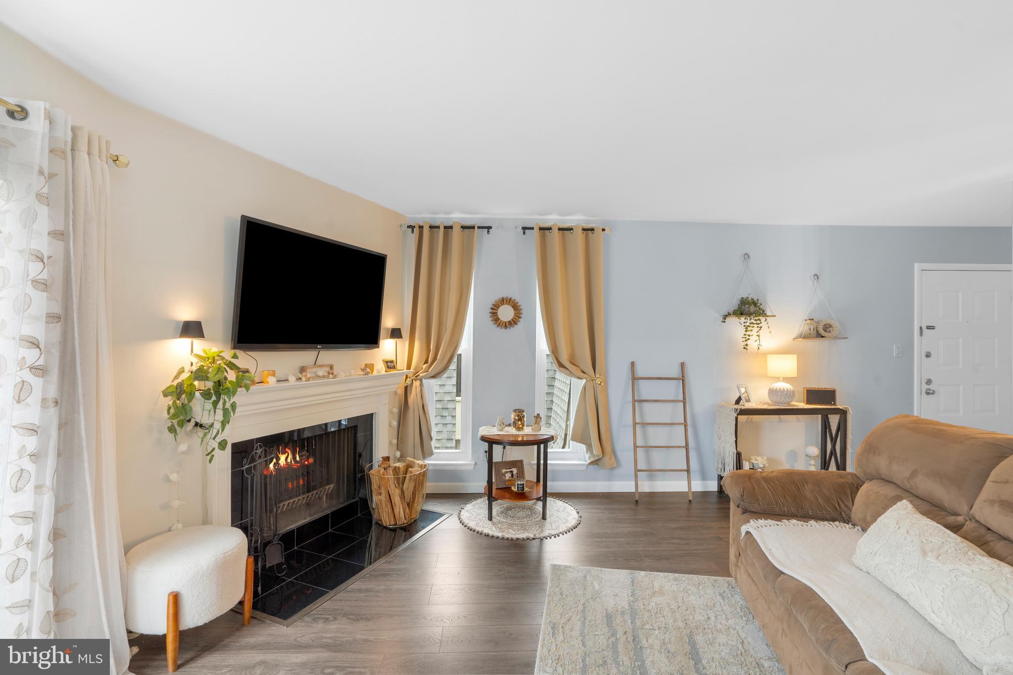 25 Church Road, Unit 56 Maple Shade, NJ 08052 - Photo 6 of 28 a living room with furniture a flat screen tv and a fireplace