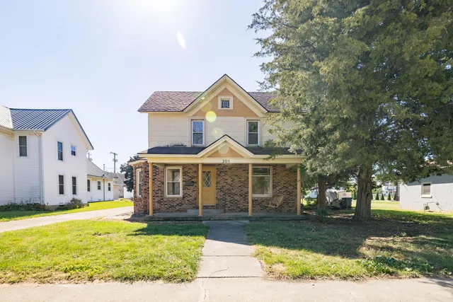 a front view of a house with a yard table and chairs