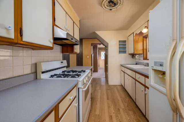 a kitchen with stainless steel appliances granite countertop a stove and a sink