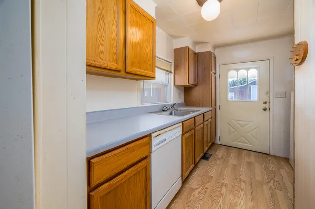 a kitchen with stainless steel appliances granite countertop a sink and cabinets