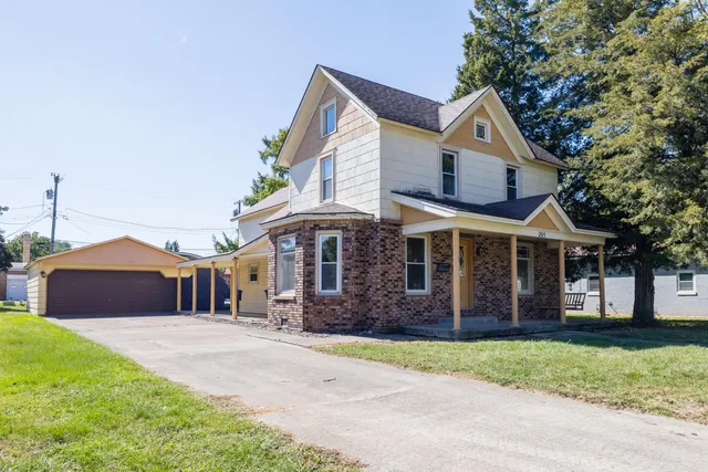 a front view of a house with a garden and plants