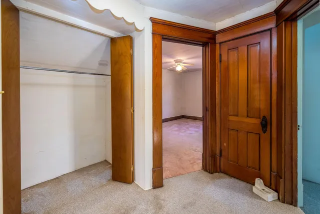 a view of a room with a wooden door