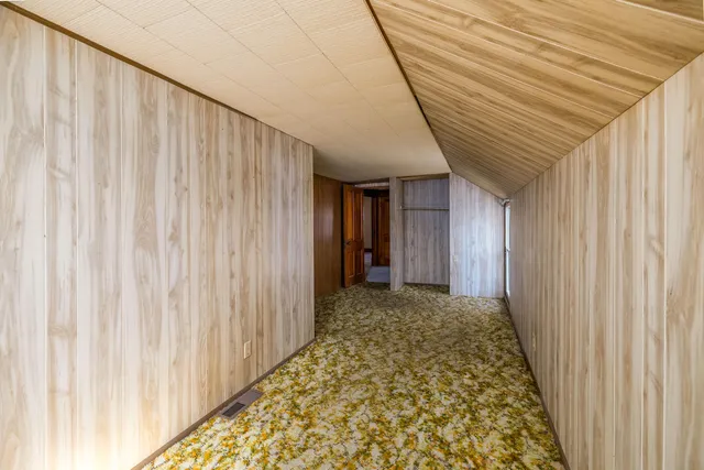 an empty room with windows and closet