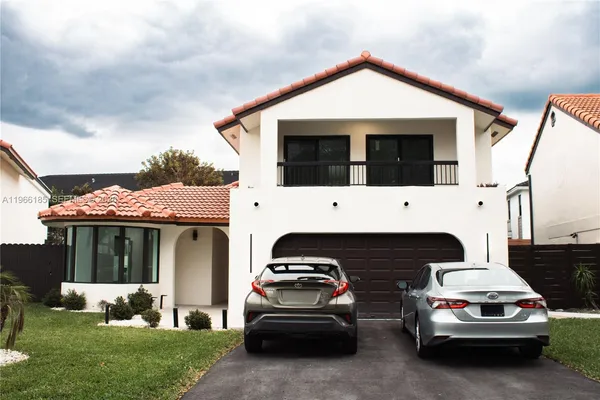 a view of a car parked in front of a house