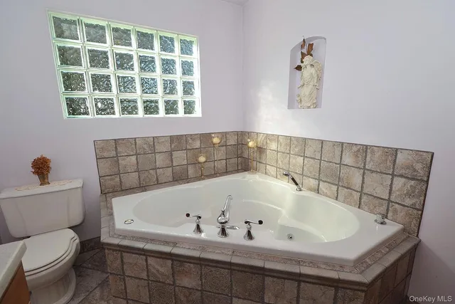 a bathroom with a bathtub and a toilet