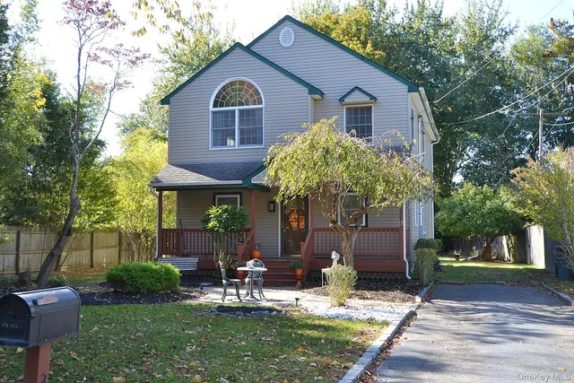 a view of house with yard and outdoor seating