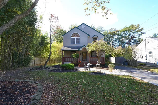 a view of a house with a yard fire pit and outdoor seating