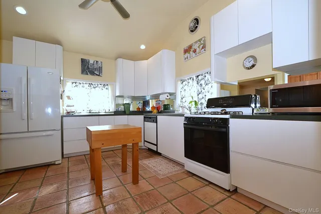 a kitchen with stainless steel appliances granite countertop a refrigerator sink and cabinets