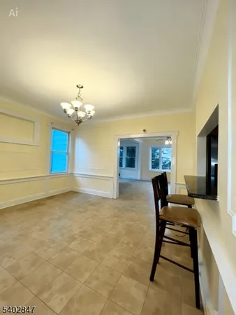 a view of a livingroom with furniture and a chandelier