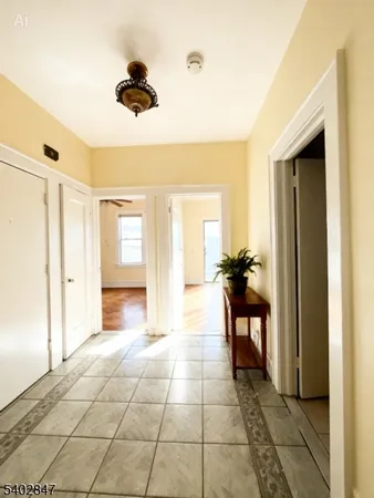 a view of a hallway to a room with a dining table and chairs