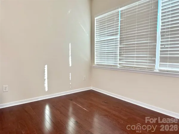 a balcony with wooden floor and fence