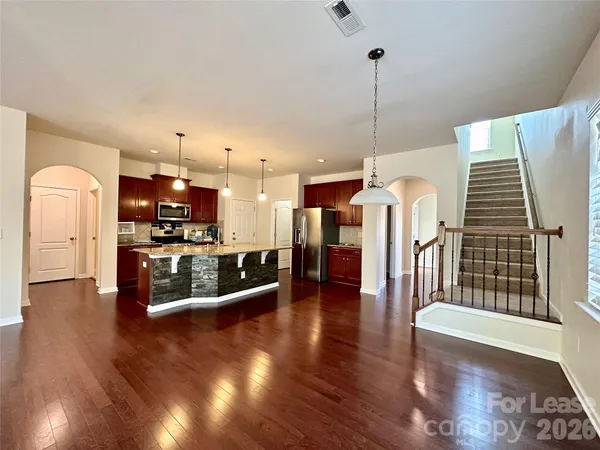 a view of a living room and kitchen with furniture