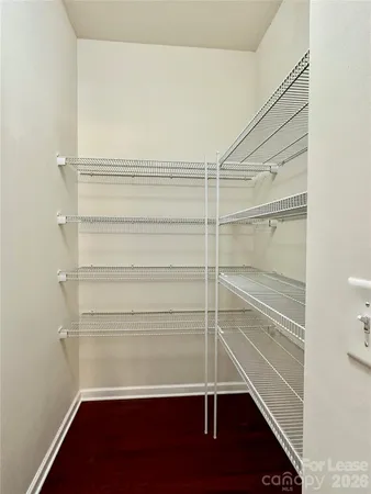 a view of walk in closet with empty racks
