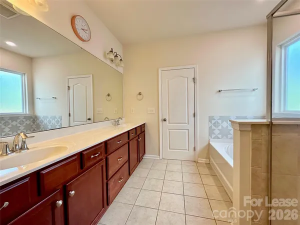 a spacious bathroom with a sink a mirror and a shower