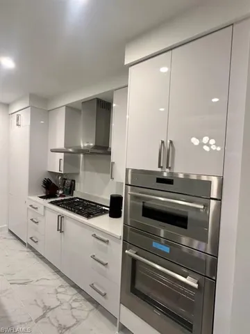 a living room with fireplace furniture and a chandelier