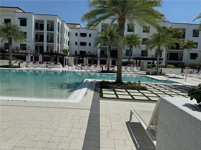 a view of a swimming pool with a table and chairs