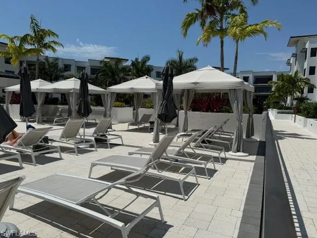 a view of a patio with swimming pool table and chairs