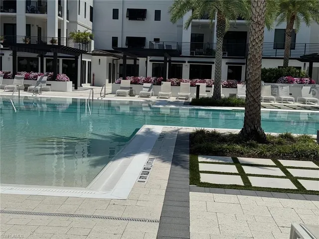 a view of swimming pool with outdoor seating
