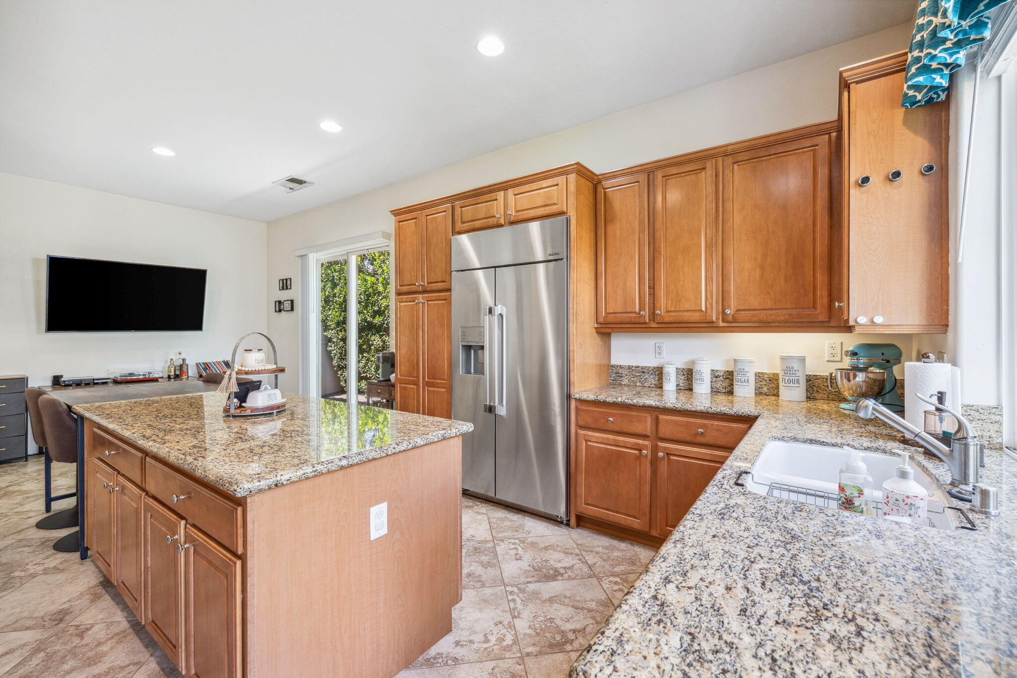 79040 Shadow Trail La Quinta, CA 92253 - Photo 27 of 69 a kitchen with stainless steel appliances granite countertop a sink dishwasher stove and refrigerator with wooden floor