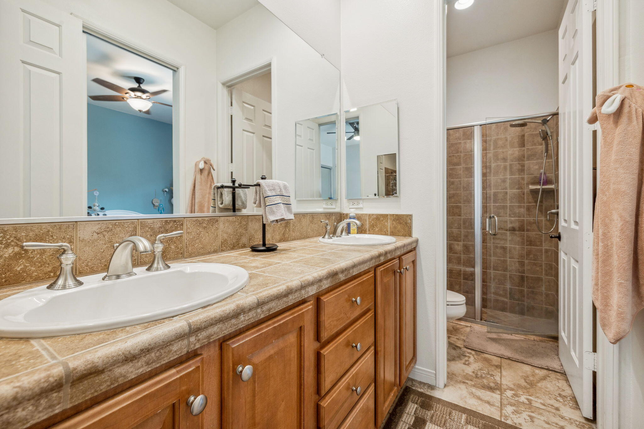 79040 Shadow Trail La Quinta, CA 92253 - Photo 49 of 69 a bathroom with a granite countertop sink a mirror and a shower