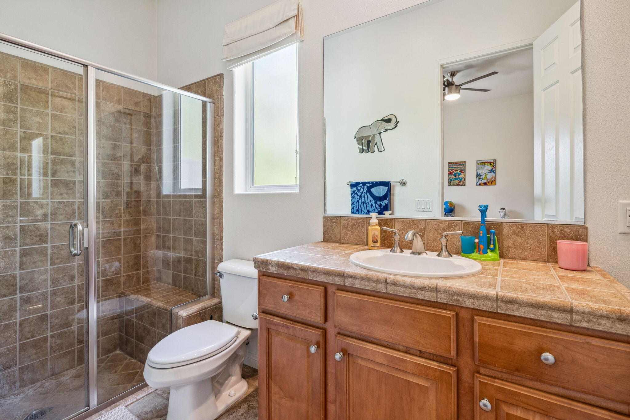 79040 Shadow Trail La Quinta, CA 92253 - Photo 56 of 69 a bathroom with a granite countertop sink toilet mirror and shower