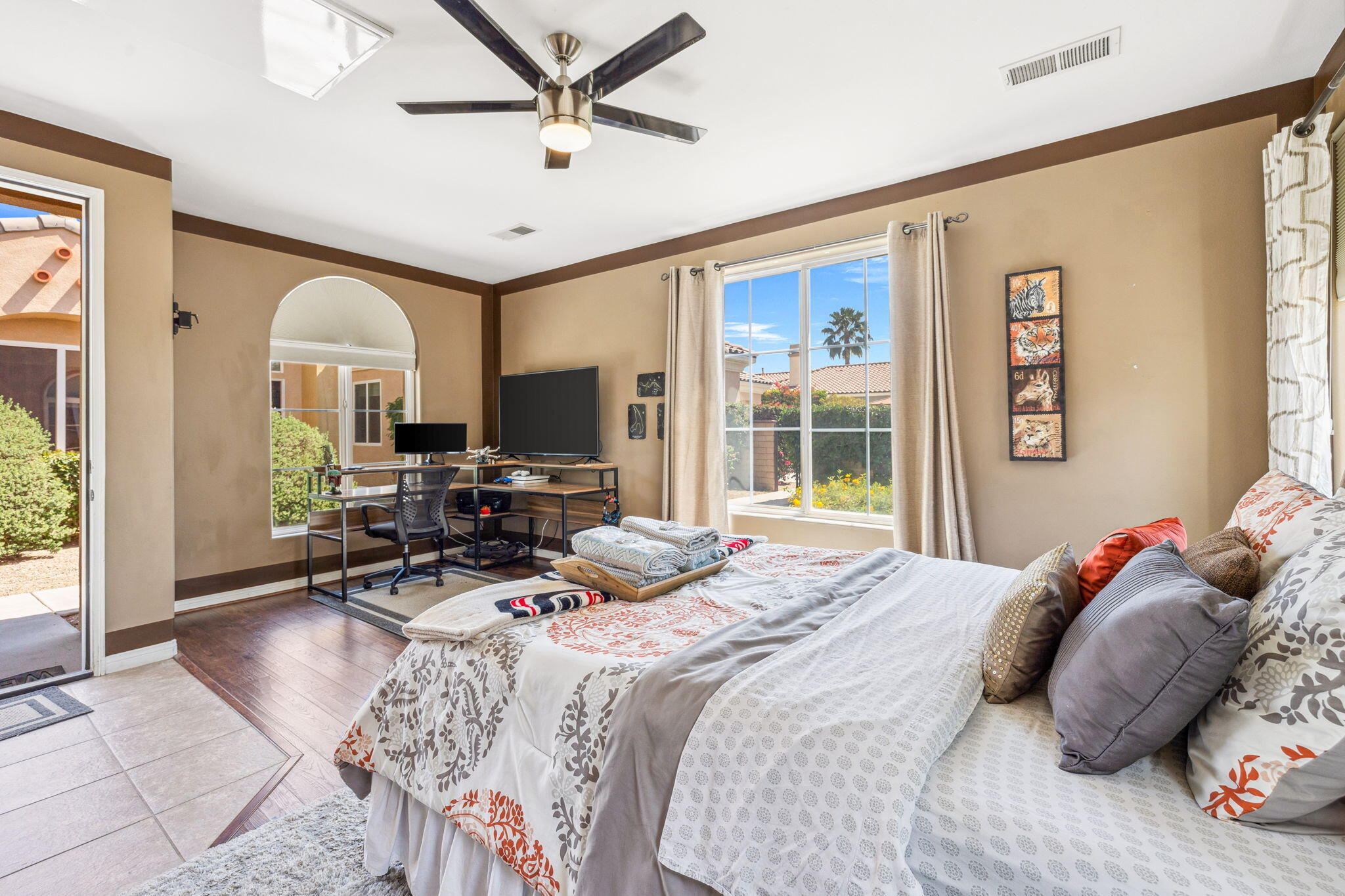 79040 Shadow Trail La Quinta, CA 92253 - Photo 59 of 69 a bedroom with a bed large window with the potted plants on the table and a large mirror on the dresser