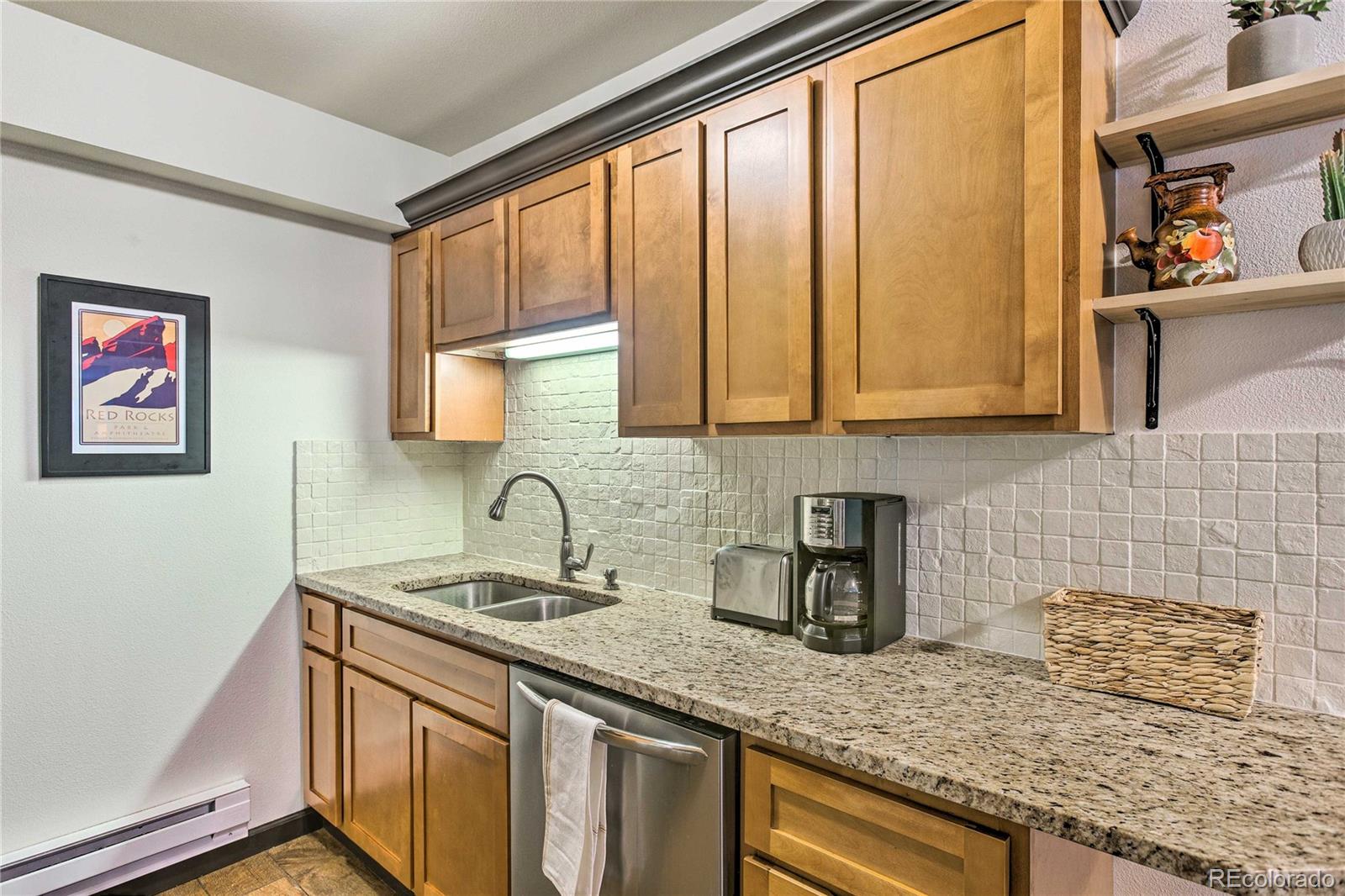 7559 South Turkey Creek Road Morrison, CO 80465 - Photo 16 of 40 a kitchen with stainless steel appliances granite countertop a sink and a window