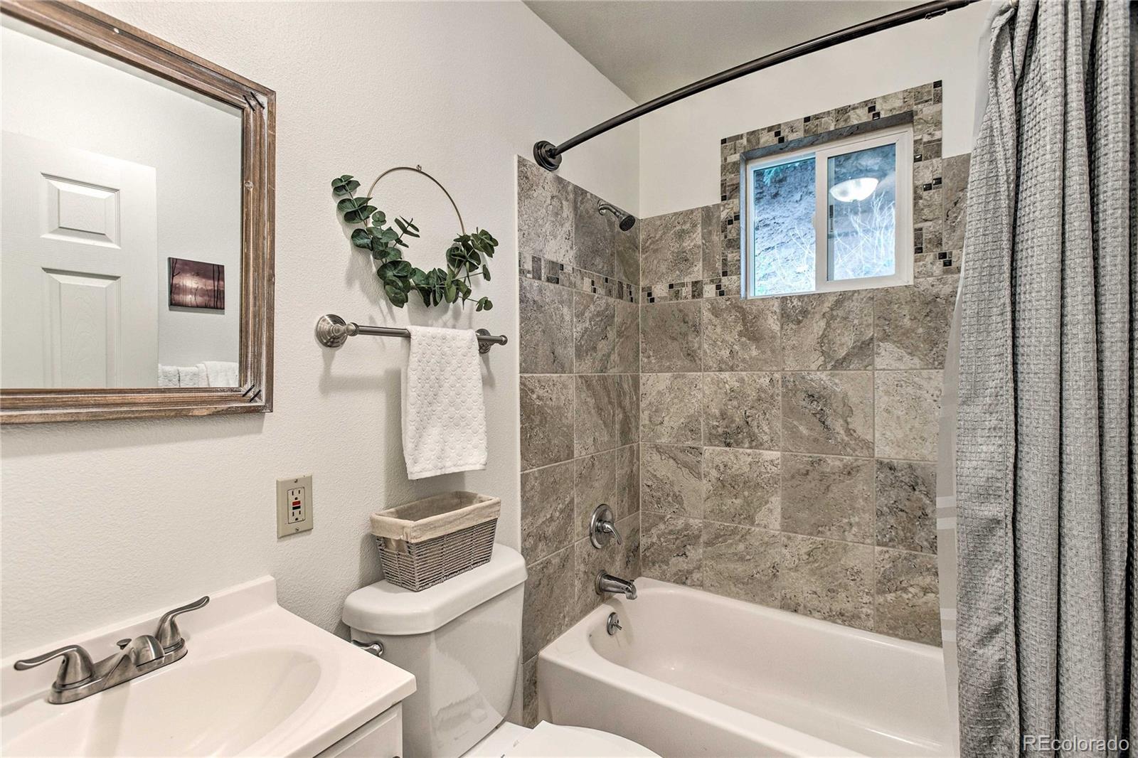 7559 South Turkey Creek Road Morrison, CO 80465 - Photo 20 of 40 a bathroom with a sink a toilet and shower