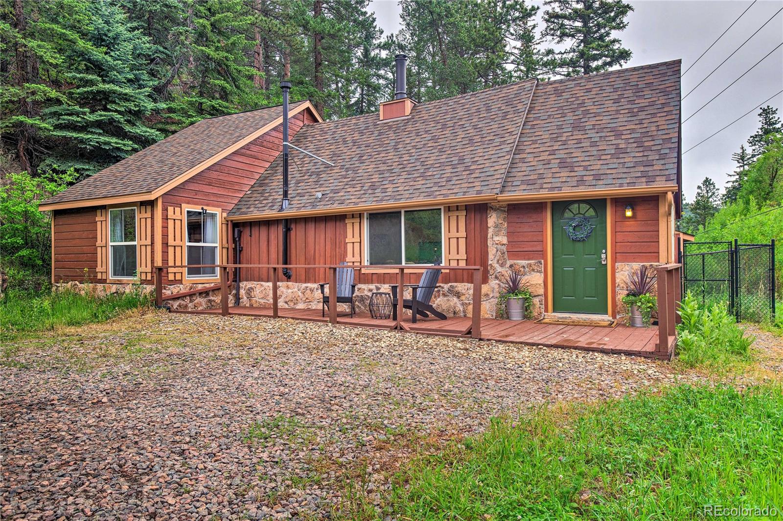 7559 South Turkey Creek Road Morrison, CO 80465 - Photo 2 of 43 a front view of a house with garden