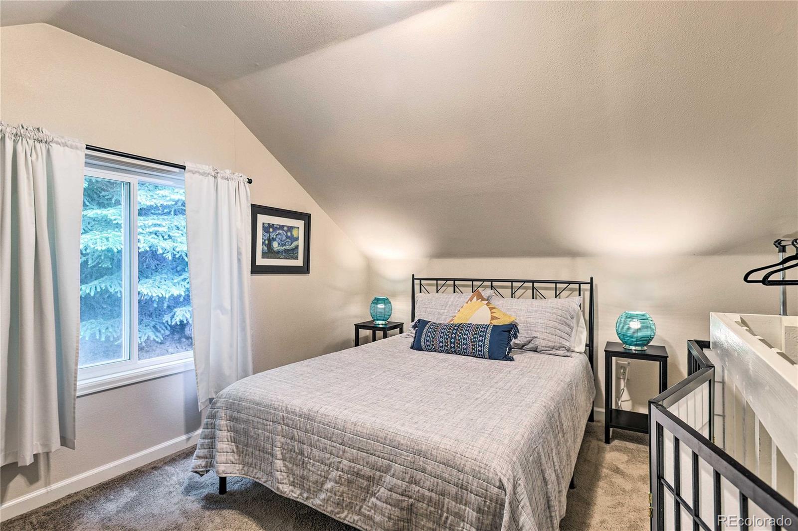 7559 South Turkey Creek Road Morrison, CO 80465 - Photo 22 of 40 a bedroom with a bed and a window