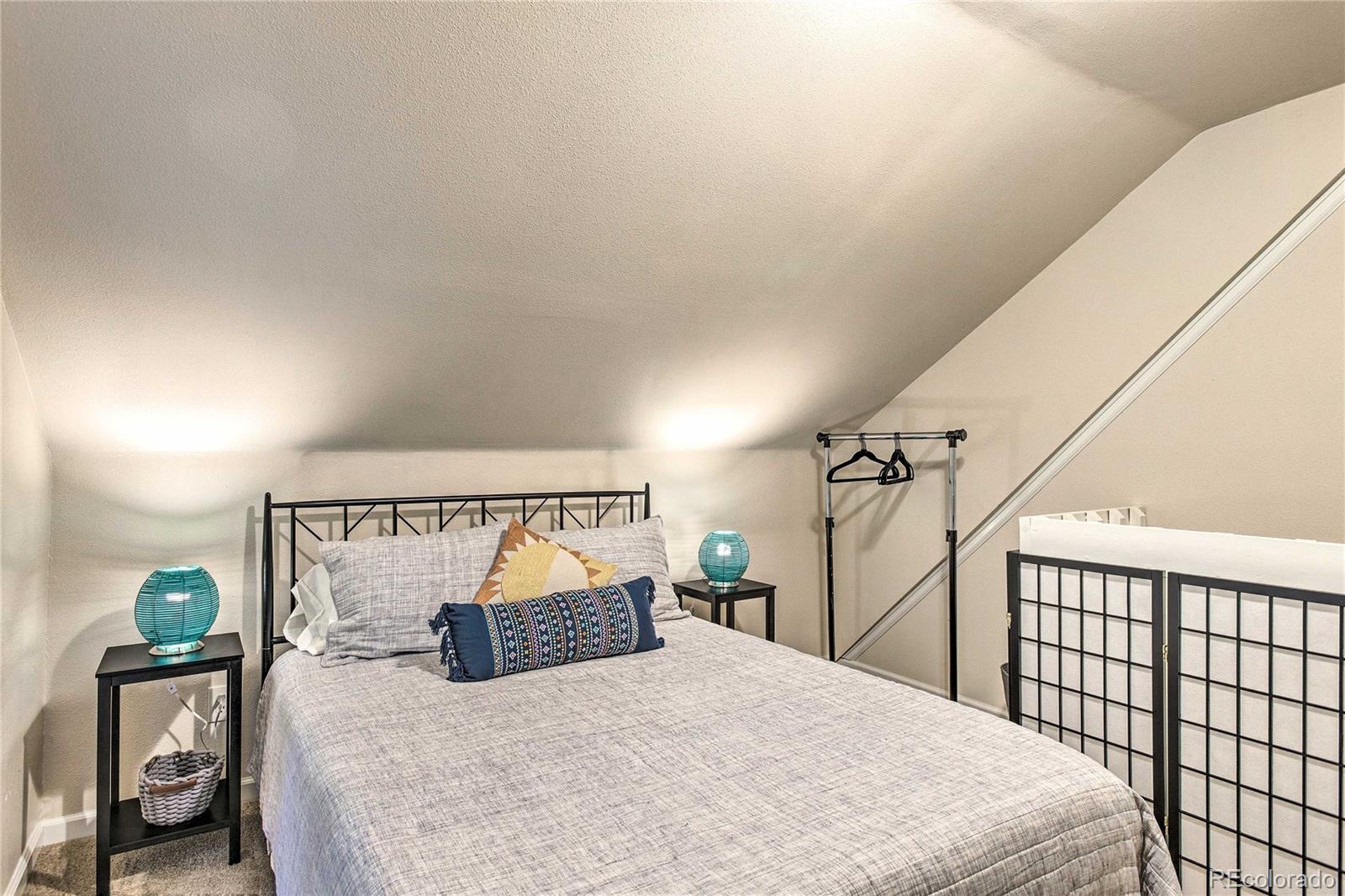 7559 South Turkey Creek Road Morrison, CO 80465 - Photo 23 of 40 a bedroom with a bed a mirror and a window