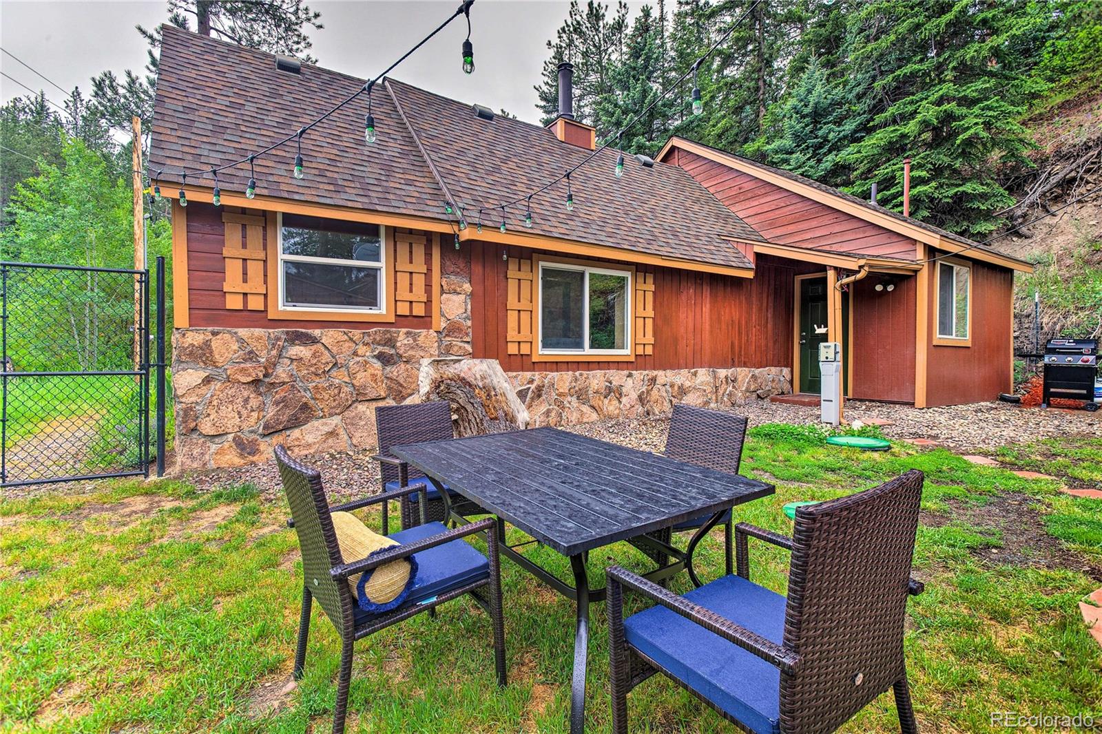 7559 South Turkey Creek Road Morrison, CO 80465 - Photo 27 of 40 a backyard of a house with table and chairs