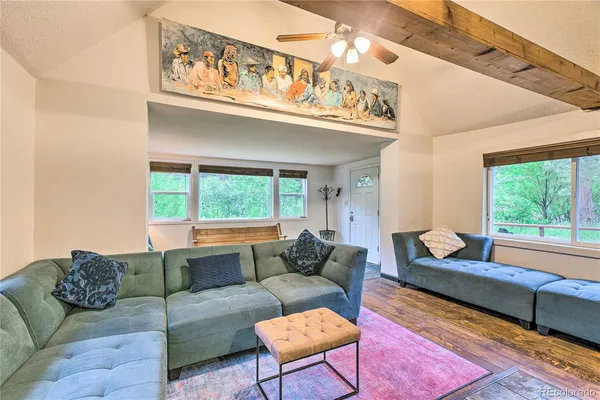 a living room with furniture and a floor to ceiling window