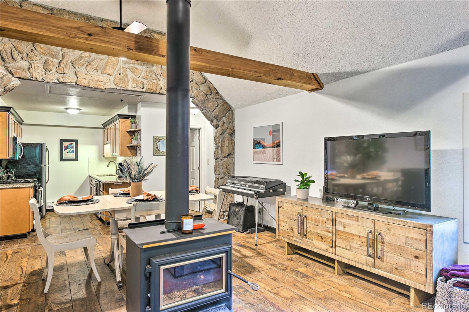 7559 South Turkey Creek Road Morrison, CO 80465 - Photo 9 of 40 a living room with furniture and a flat screen tv