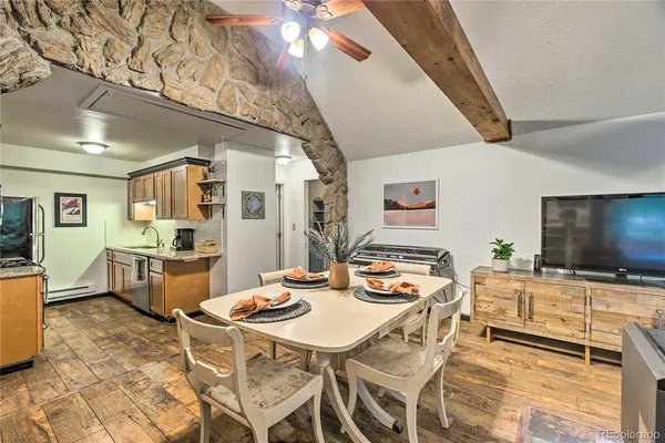 a dining room with furniture a rug and wooden floor