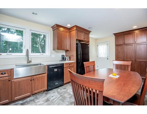 40 Woodruff Road Walpole, MA 02081 - Photo 11 of 31 a kitchen with stainless steel appliances granite countertop a sink a stove a refrigerator a washer dryer and a dining table