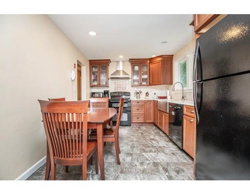 40 Woodruff Road Walpole, MA 02081 - Photo 12 of 31 a dining room with a sink chairs and kitchen view