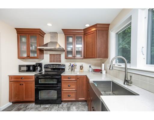 40 Woodruff Road Walpole, MA 02081 - Photo 14 of 31 a kitchen with stainless steel appliances granite countertop a sink stove and cabinets
