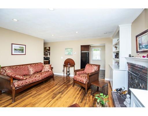 40 Woodruff Road Walpole, MA 02081 - Photo 8 of 31 a living room with furniture and a dining table with rug