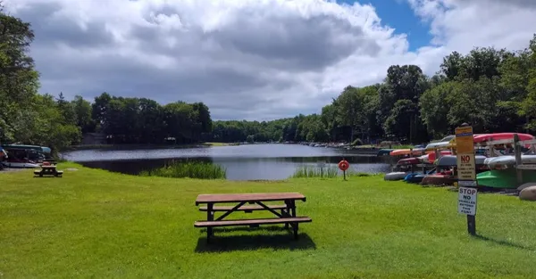 a swimming pool with lawn chairs and a yard