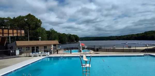 swimming pool view with a seating space