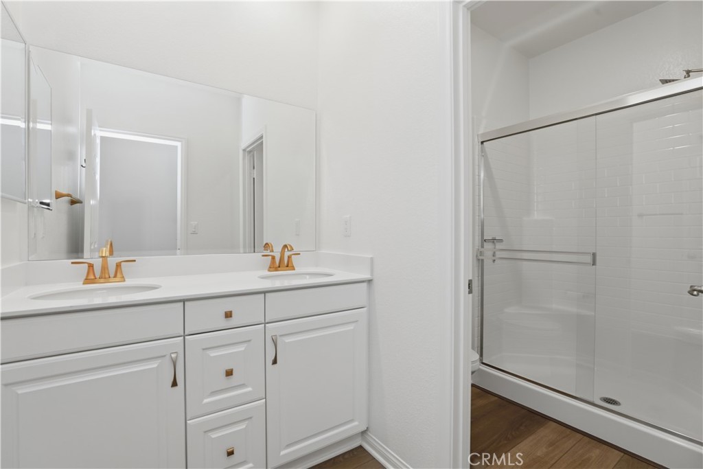 21159 Blue Jeans Court Riverside, CA 92507 - Photo 48 of 63 a bathroom with a shower sink and mirror