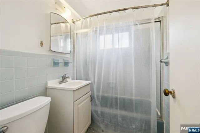 a bathroom with a shower a toilet and sink
